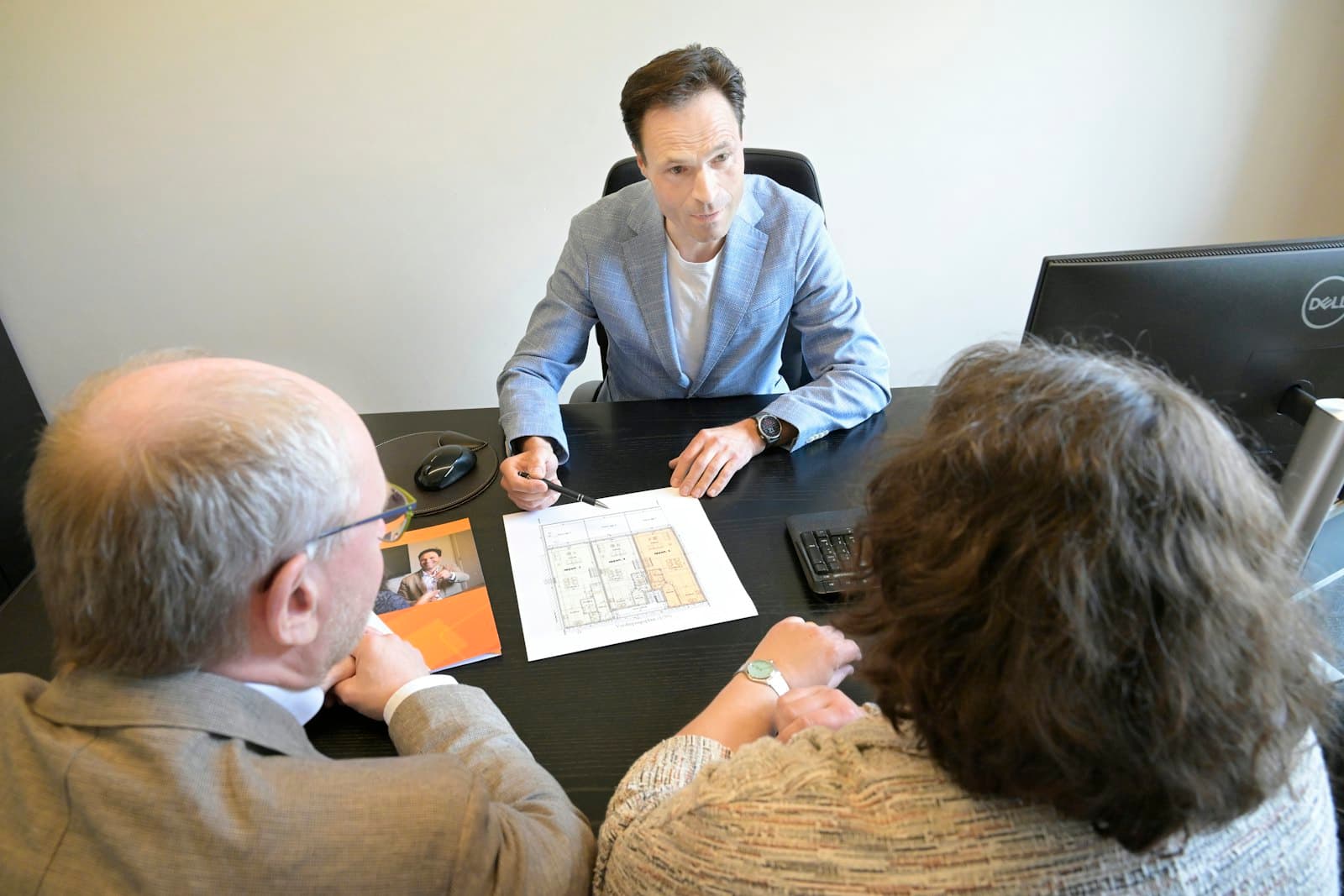 An advisor going over plans with an older couple