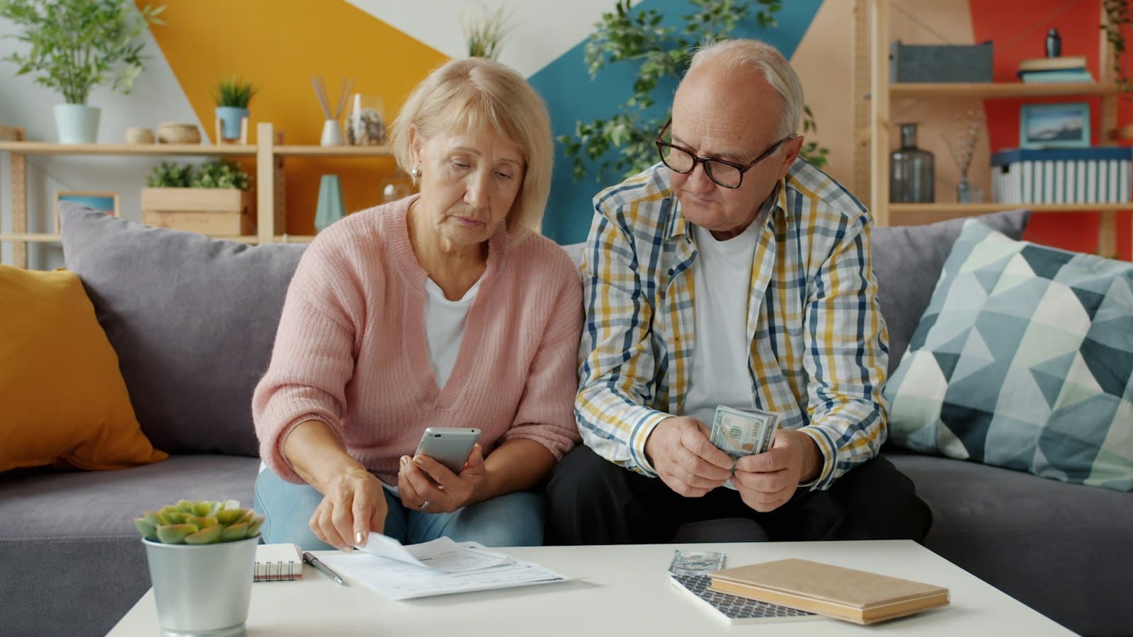 An older couple going over their bills together at home