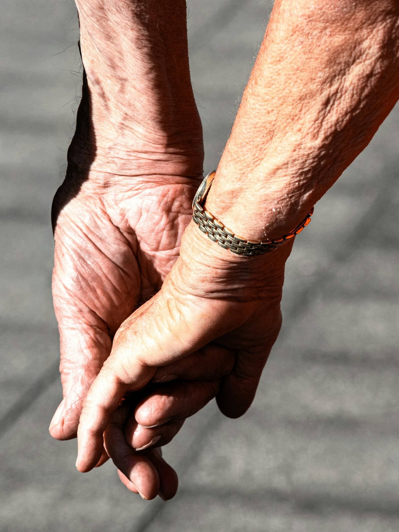 An older couple holding hands