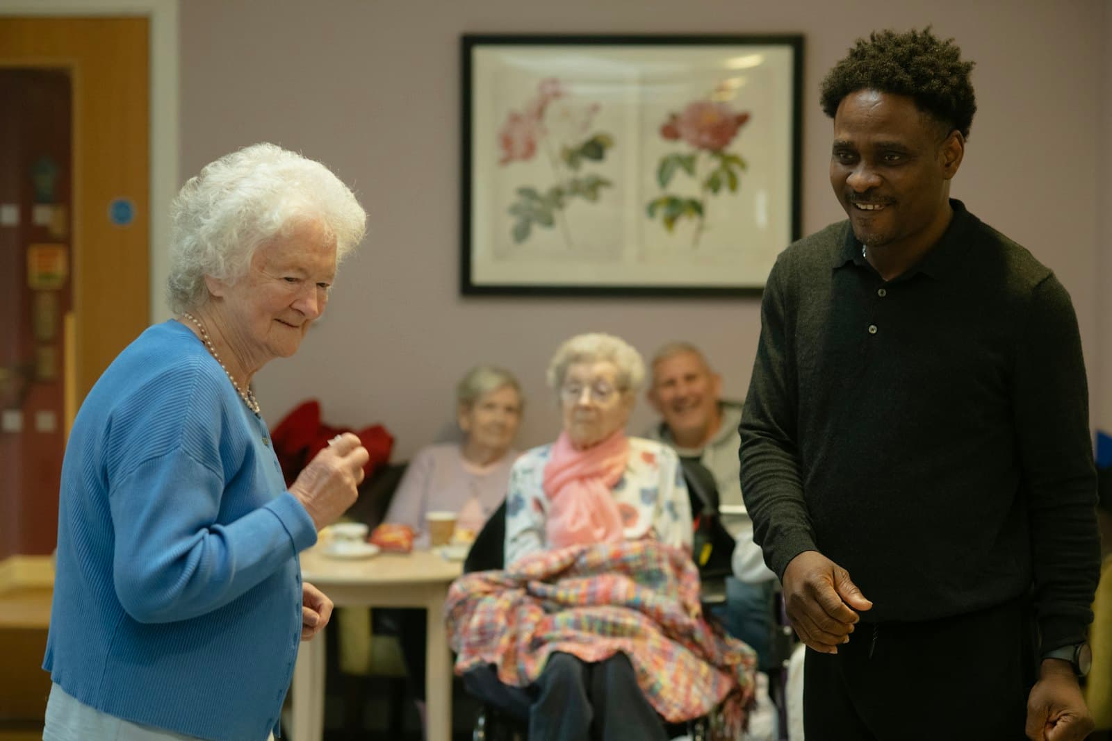 Residents and a staff member chatting in a retirement residence lounge